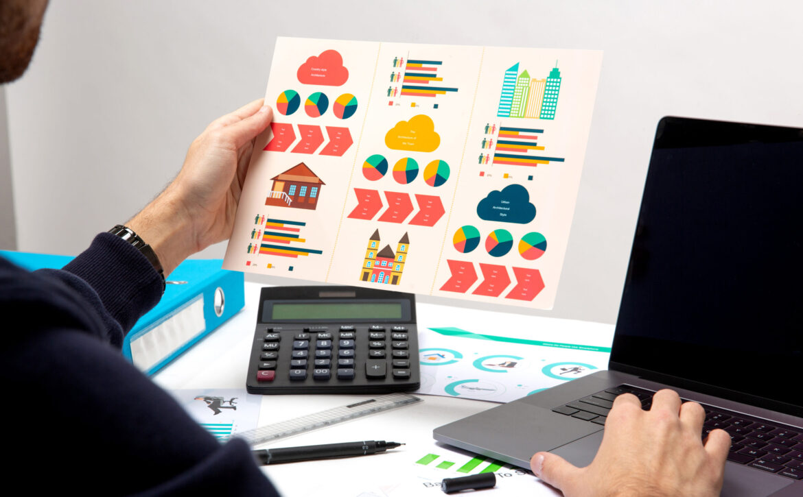 a person holds paper with drawings
